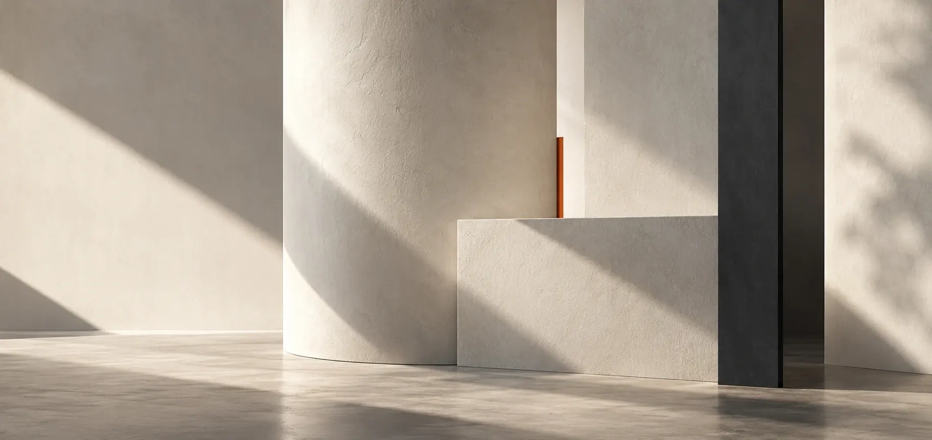 Abstract architectural composition of pale plaster planes, a curved form, a charcoal edge and a slender burnt-orange detail in natural light